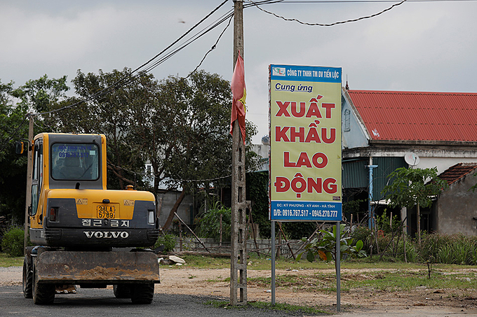 An advertising billboard for a labor export company in Ha Tinh Province, October 28, 2019. Photo by Reuters/Kham.