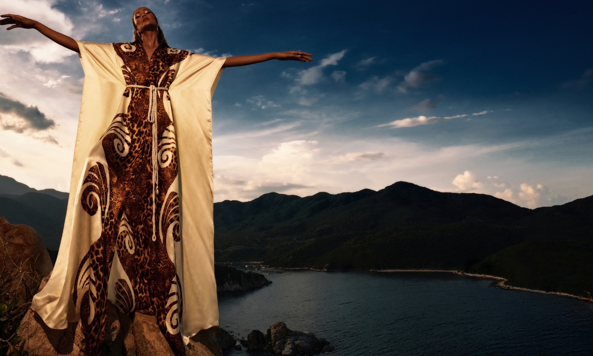 The beauty queen wears an oversized dress with nature-inspired patterns.