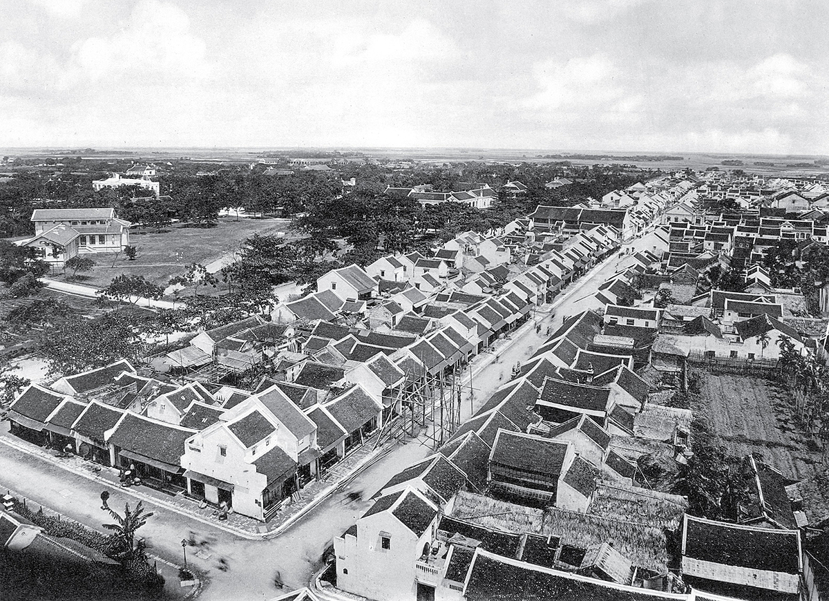 The downtown area of Nam Dinh Province is viewed from above with tiled roof architecture and close-up houses.